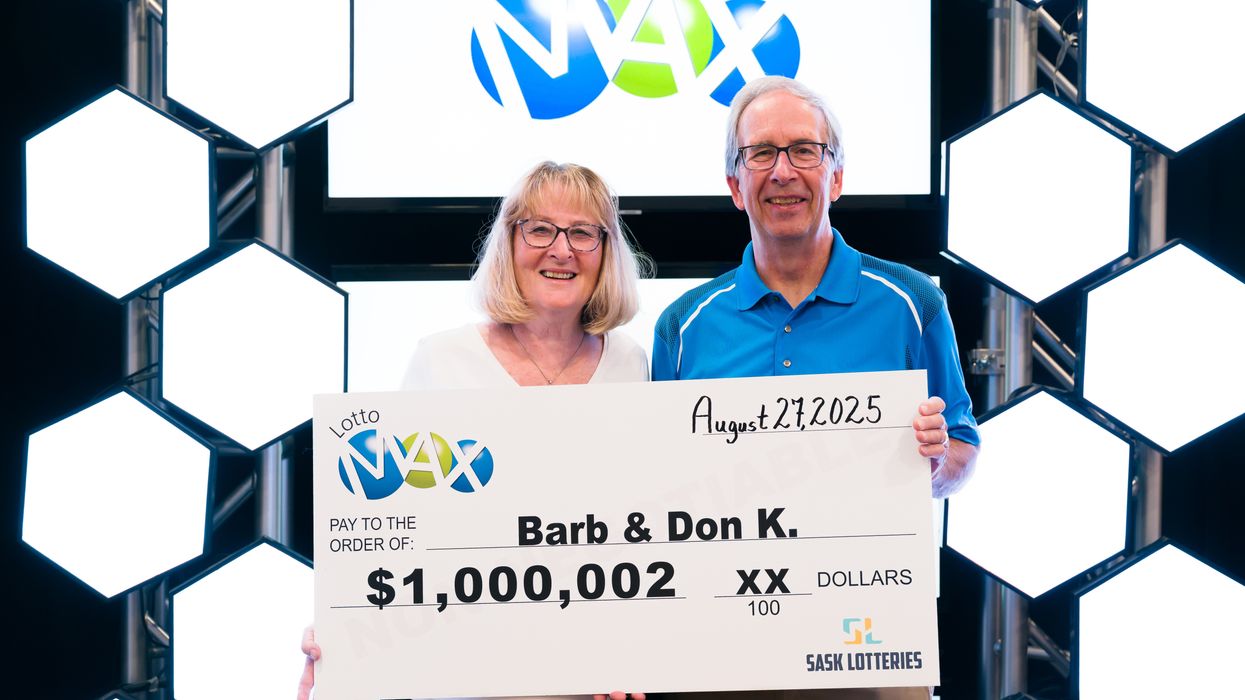 lotto max winners barb and don kostiuk holding a $1 million cheque