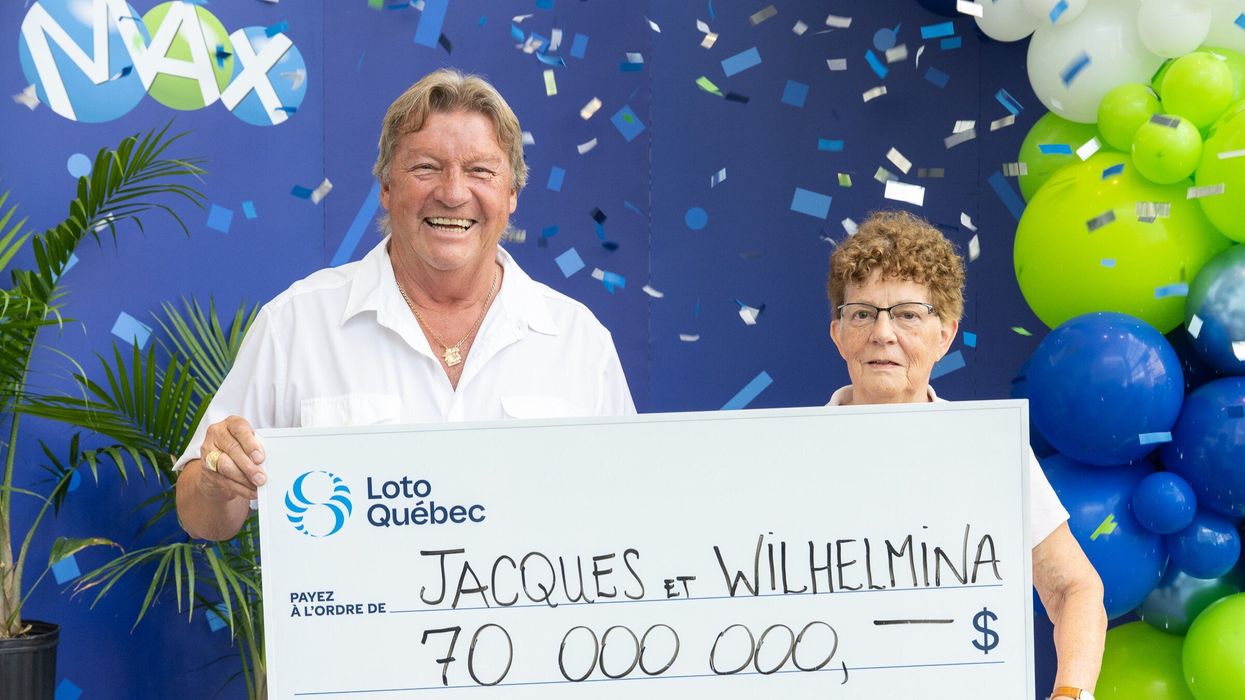 lotto max winners jacques deschamps and wilhelmina van leeuwen holding a $70 million lotto max cheque