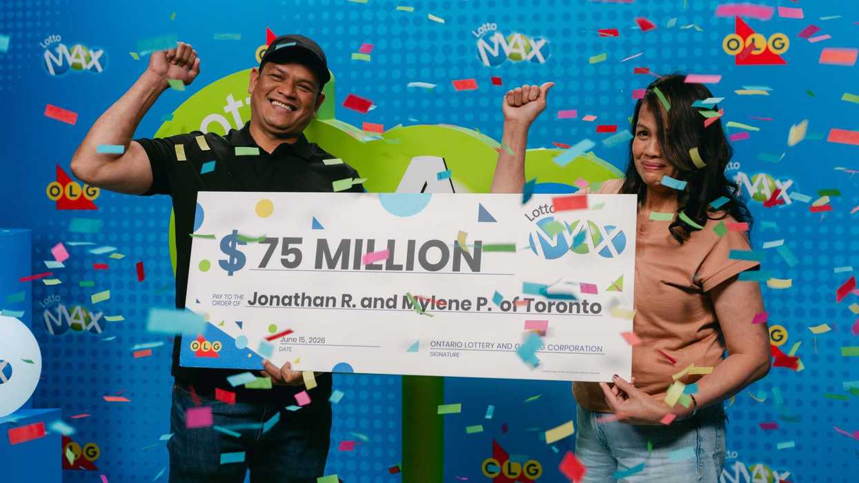 lotto max winners Jonathan R. and Mylene P. holding a $75 million cheque