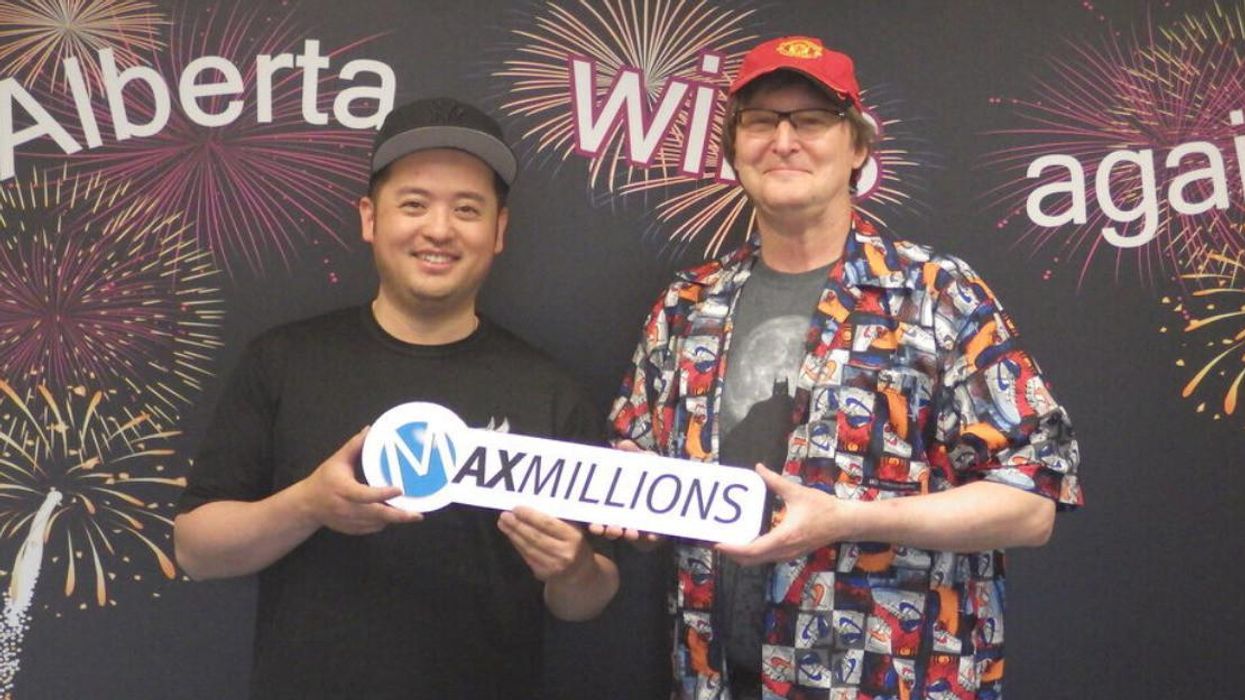 Lotto Max winners Stewart Harrison and Trieu Huynh.