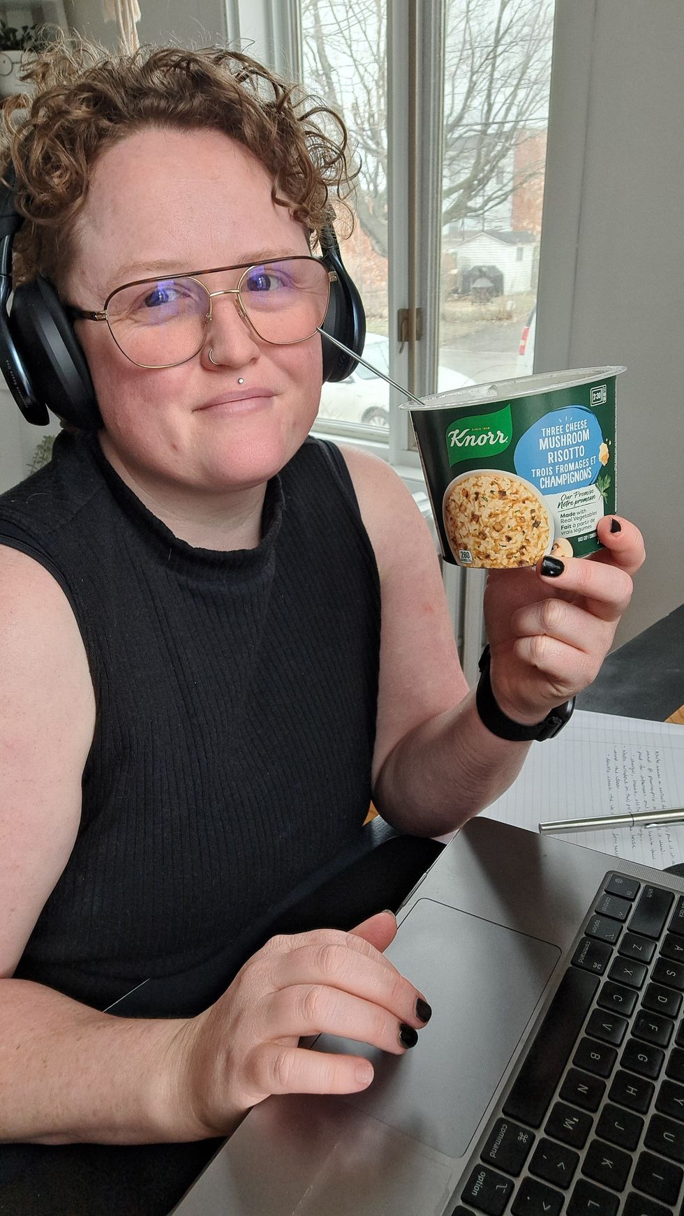 Louie Murray eating the Three Cheese Mushroom Risotto while working at a laptop.