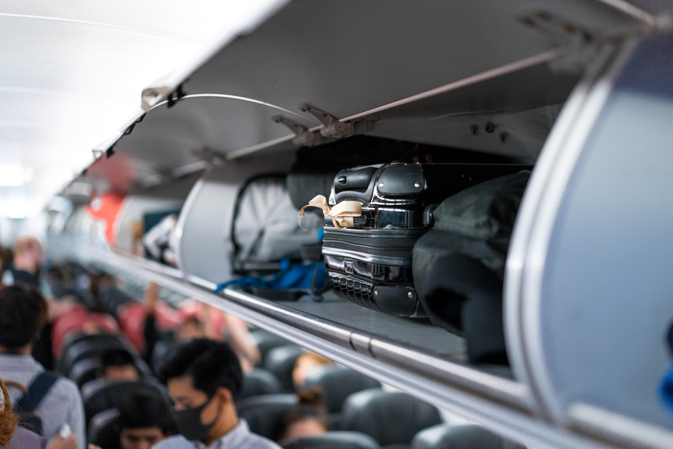 Luggage in an overhead bin.
