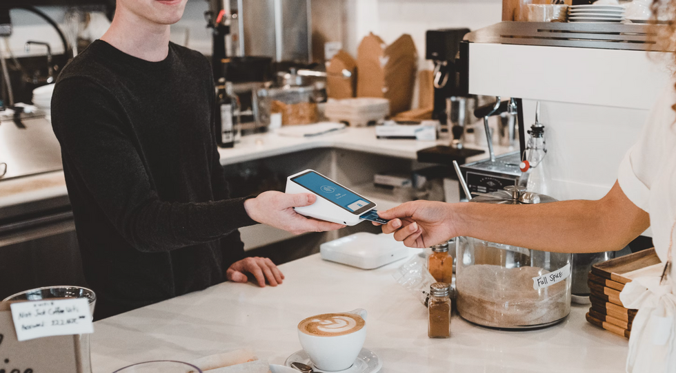 Man paying with credit card at the coffee shop