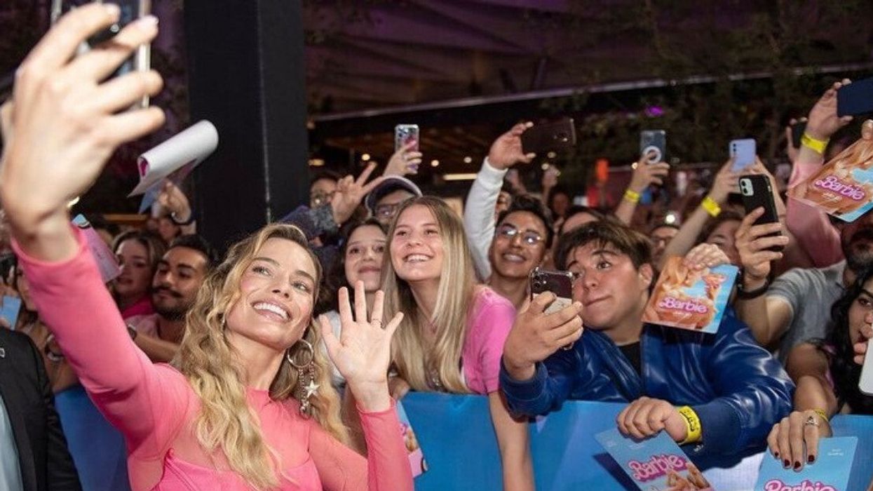 Margot Robbie with "Barbie" fans at a promotional event for the movie.