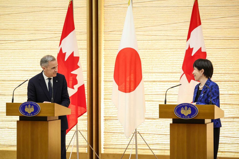 Mark Carney and Sanae Takaichi speak at podiums.