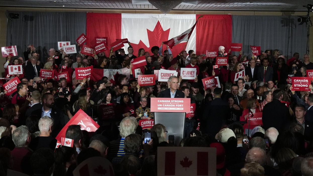 mark carney in a crowd at federal election campaign rally with canadian flags