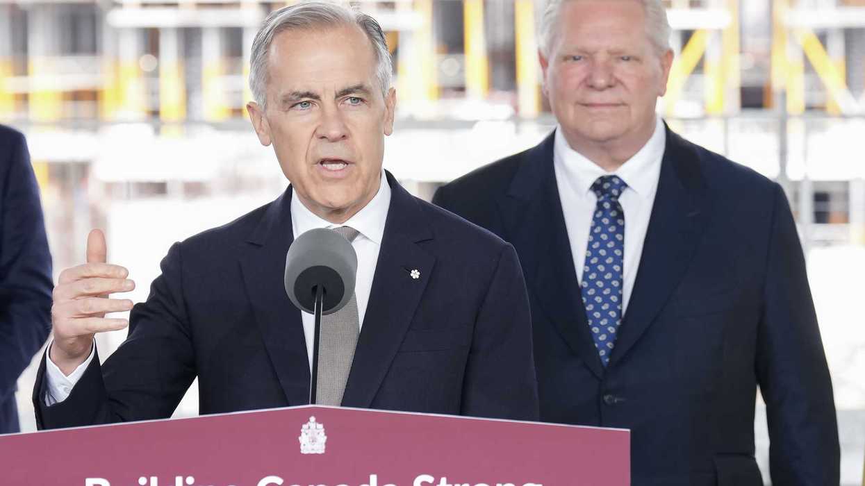 Mark Carney speaks at a podium labelled "Building Canada Strong," with Doug Ford smiling behind him.
