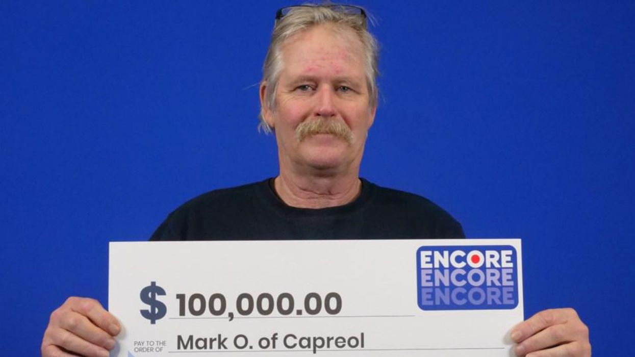 Mark Owens grabbing his cheque for $100,000.