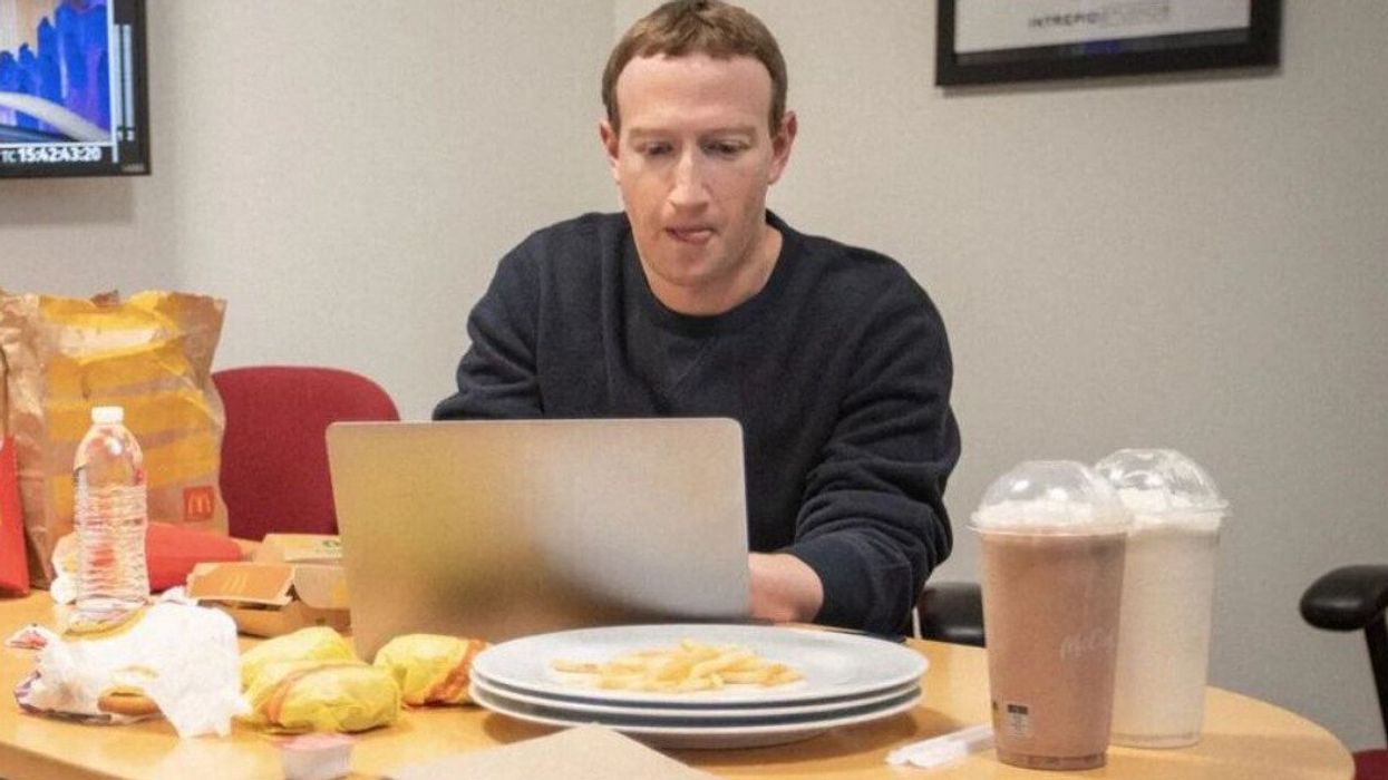 Mark Zuckerberg surrounded by McDonald's food.