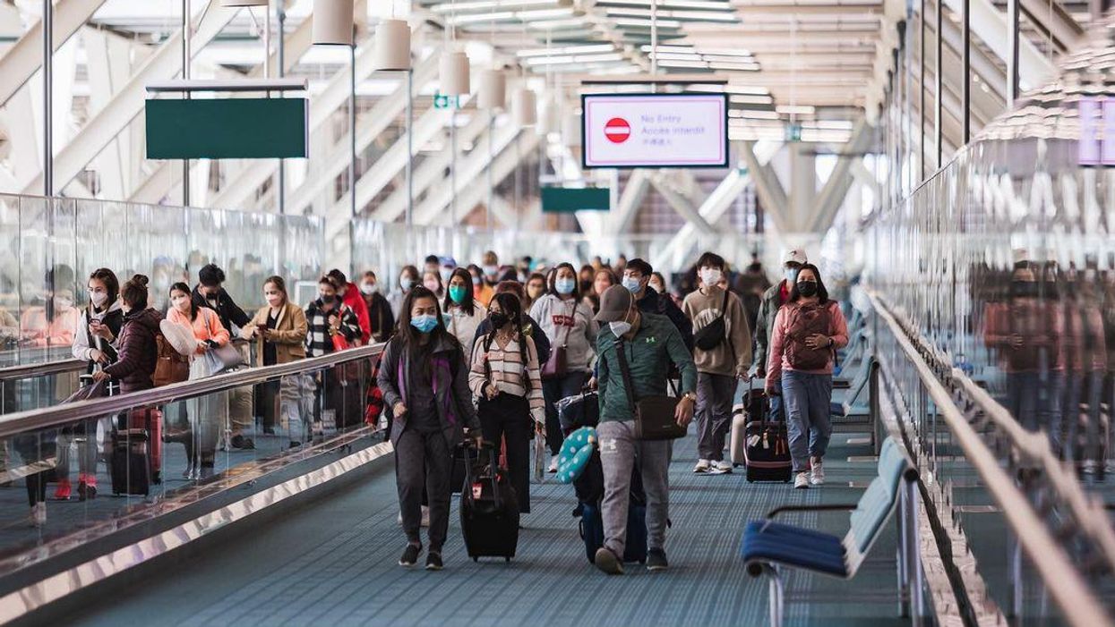 Masked passengers at the Winnipeg Airport.