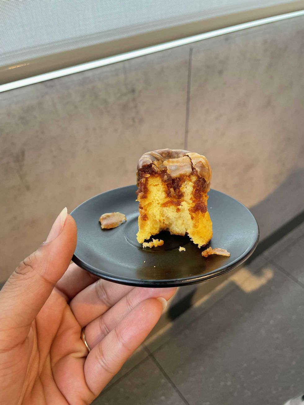 McDonald's Pudding Cake on a black plate, with a bite missing.