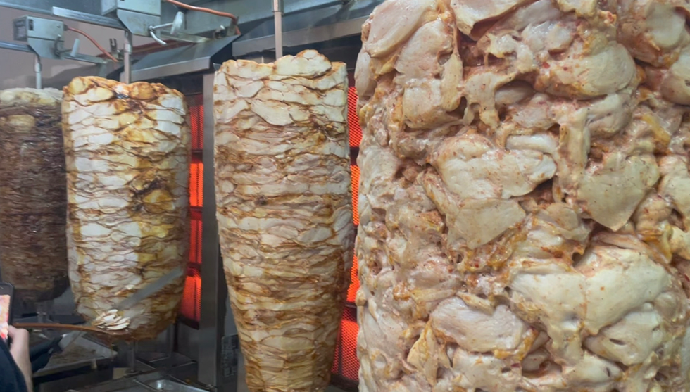 Meat on a rotisserie at Yaseen's Shawarma.