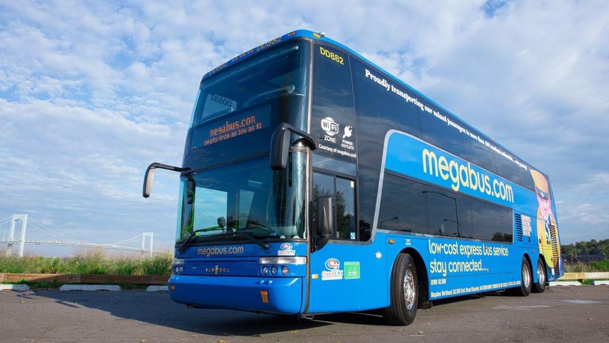 Megabus parked on the road a sunny day.