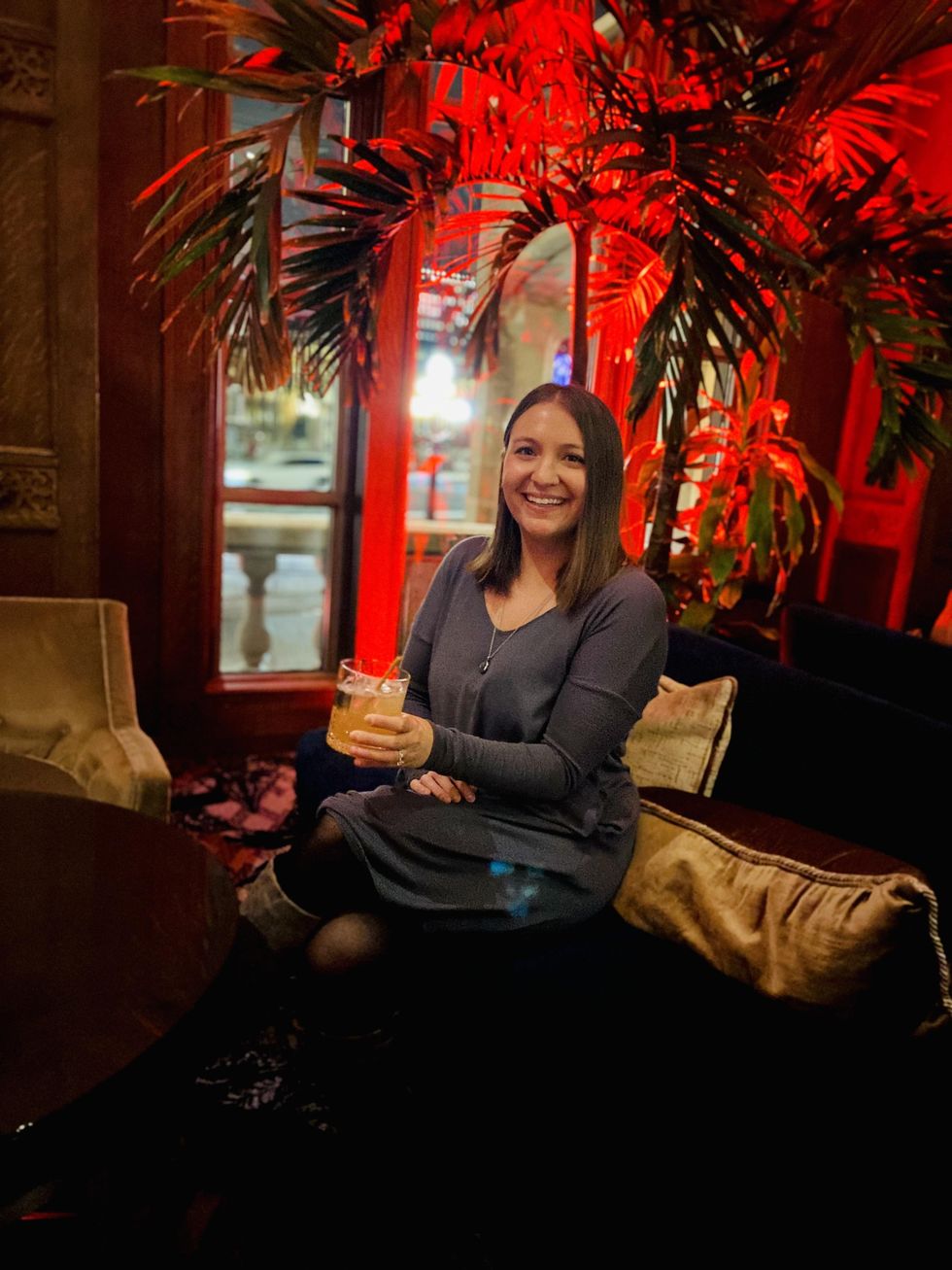 Megan drinking a cocktail at the Reading Lounge in Chateau Laurier.