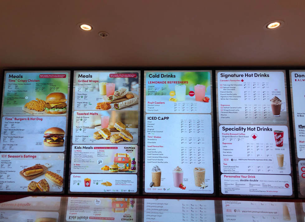 Menu screens at a Tim Hortons in England.