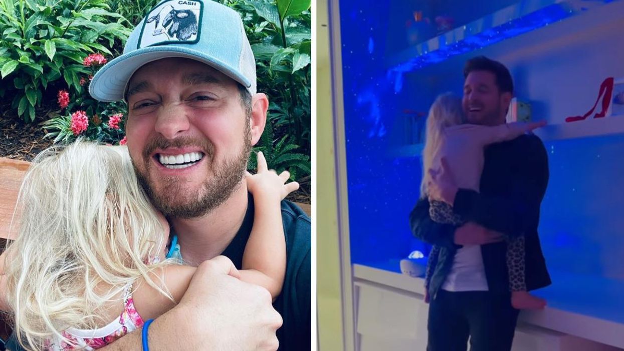 Michael Bublé holding his daughter.