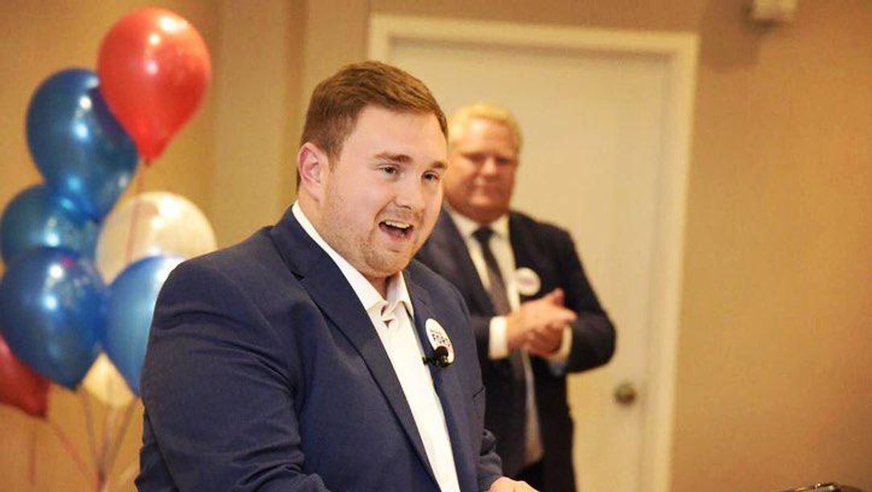 Michael Ford gives a speech with Doug Ford in the background.