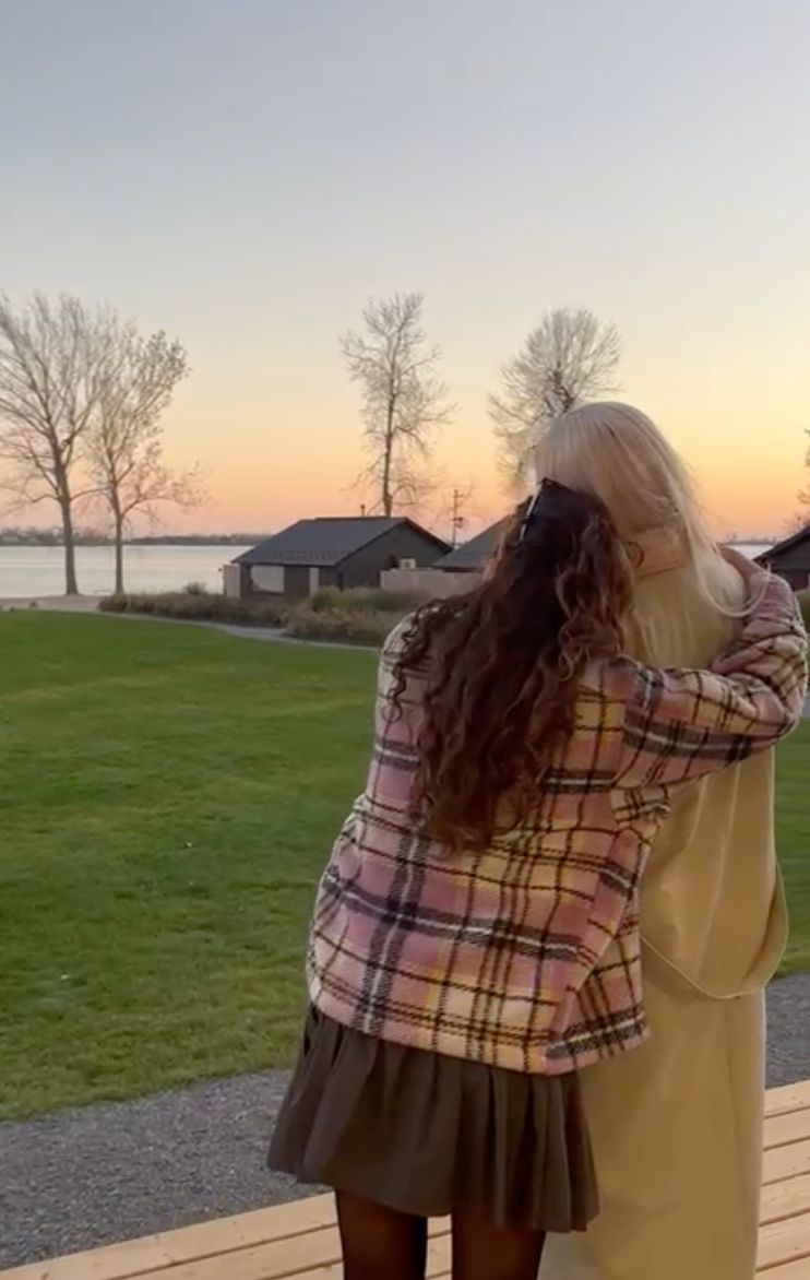 Mira and her friend watching the sunset.