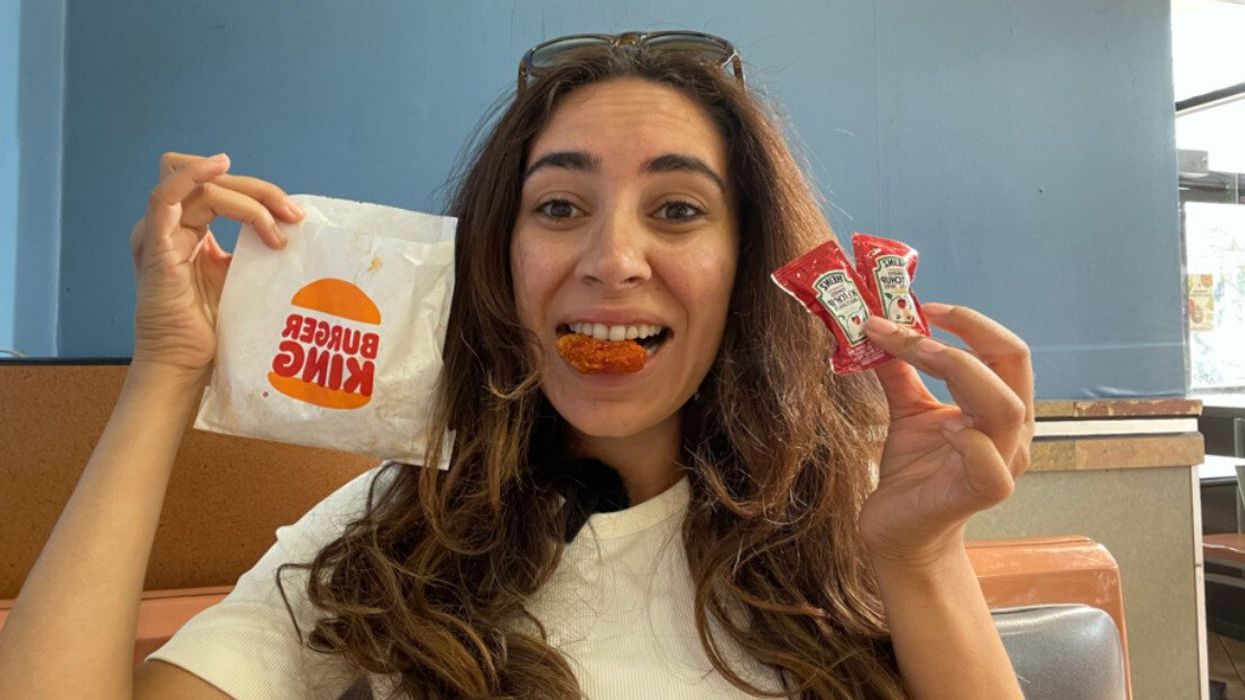 Mira at Burger King holding ketchup and eating Ketchup Nuggets.