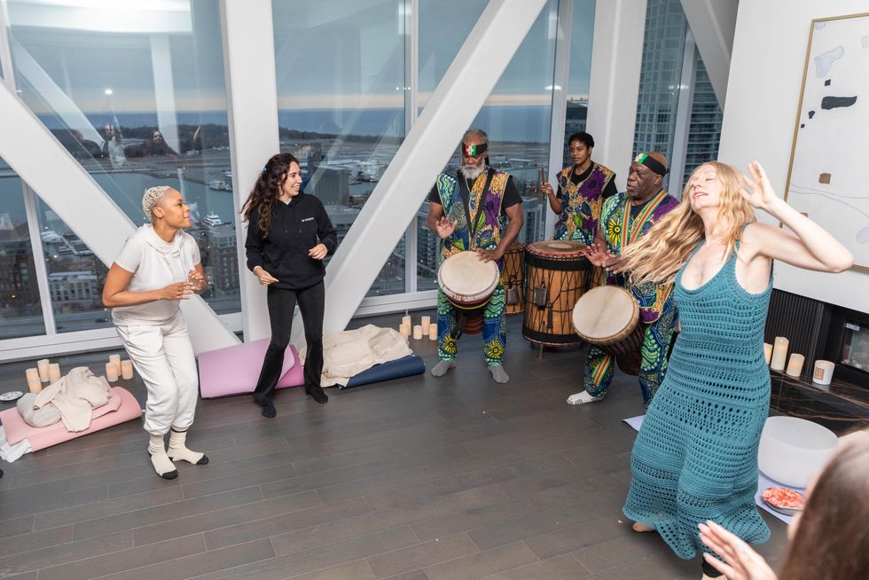 Mira dancing with others in The Bridge Suite.