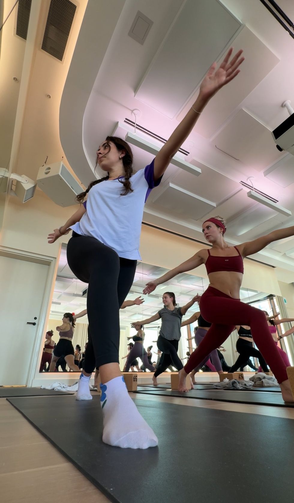 Mira doing a yoga pose during class.