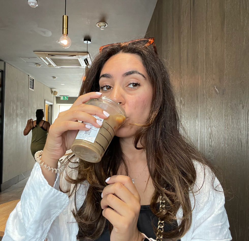 Mira drinking her iced latte from Starbucks.