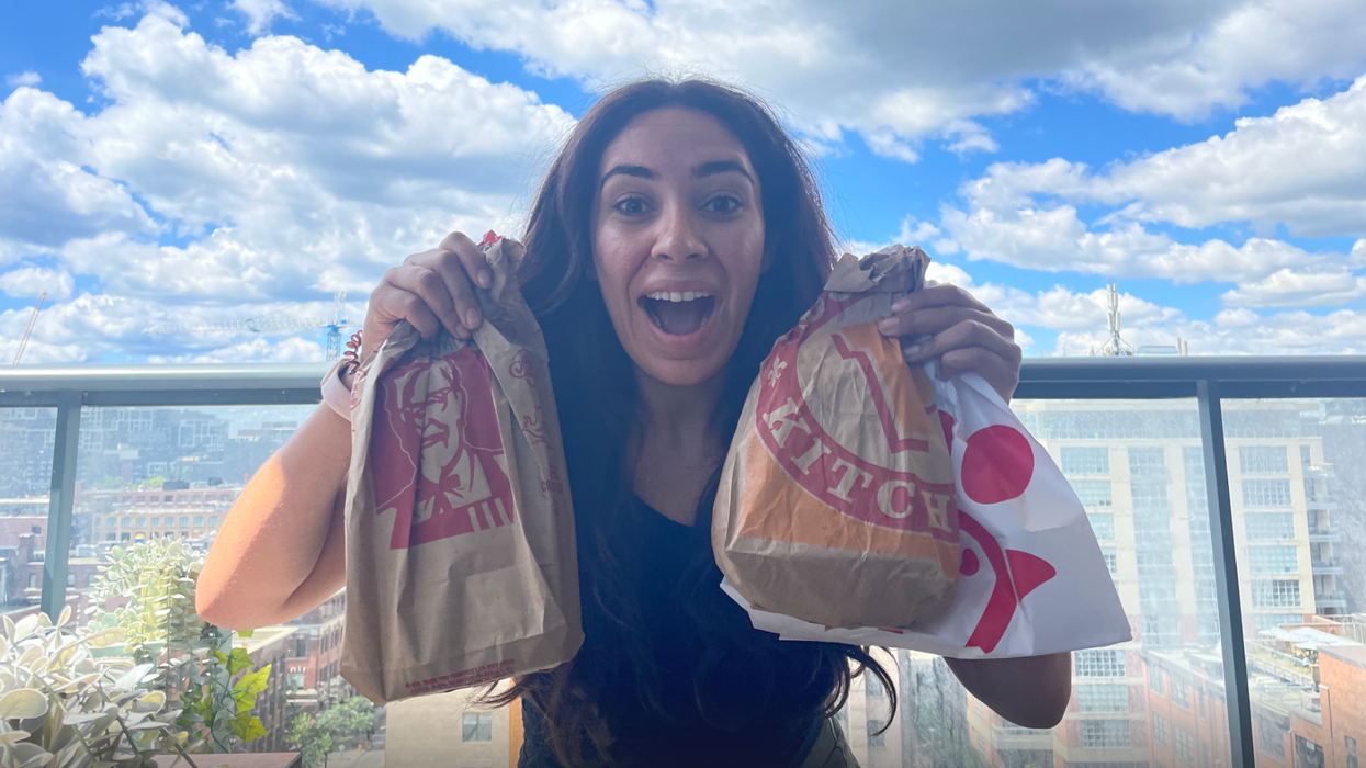 Mira holding bags of her fried chicken.