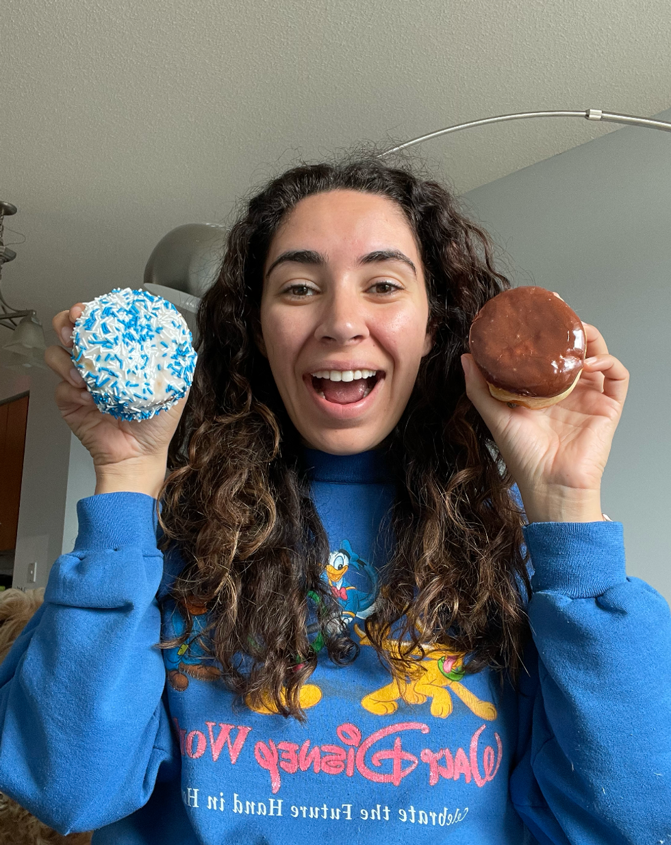 Mira holding both donuts.