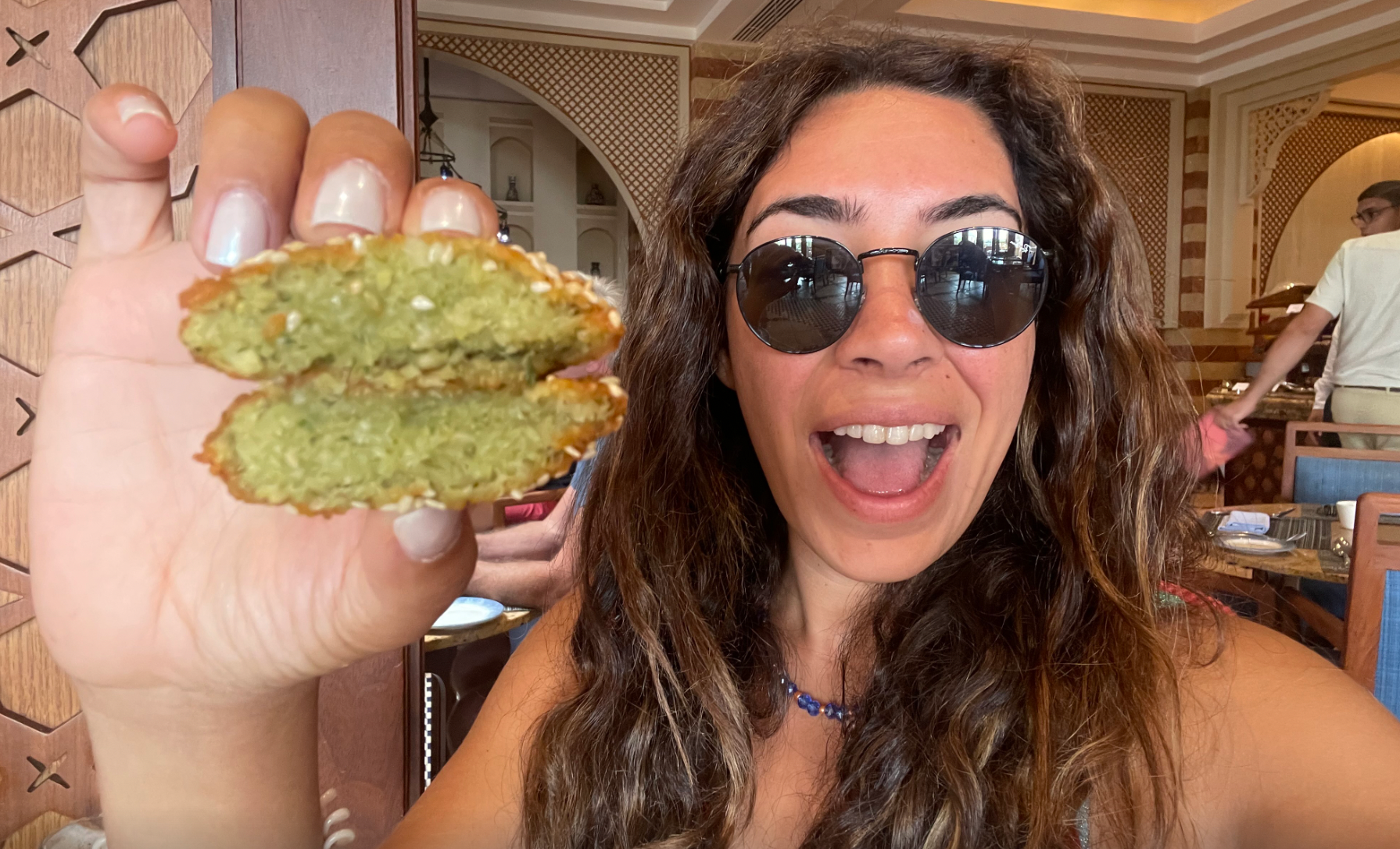 Mira holding falafel in Egypt.