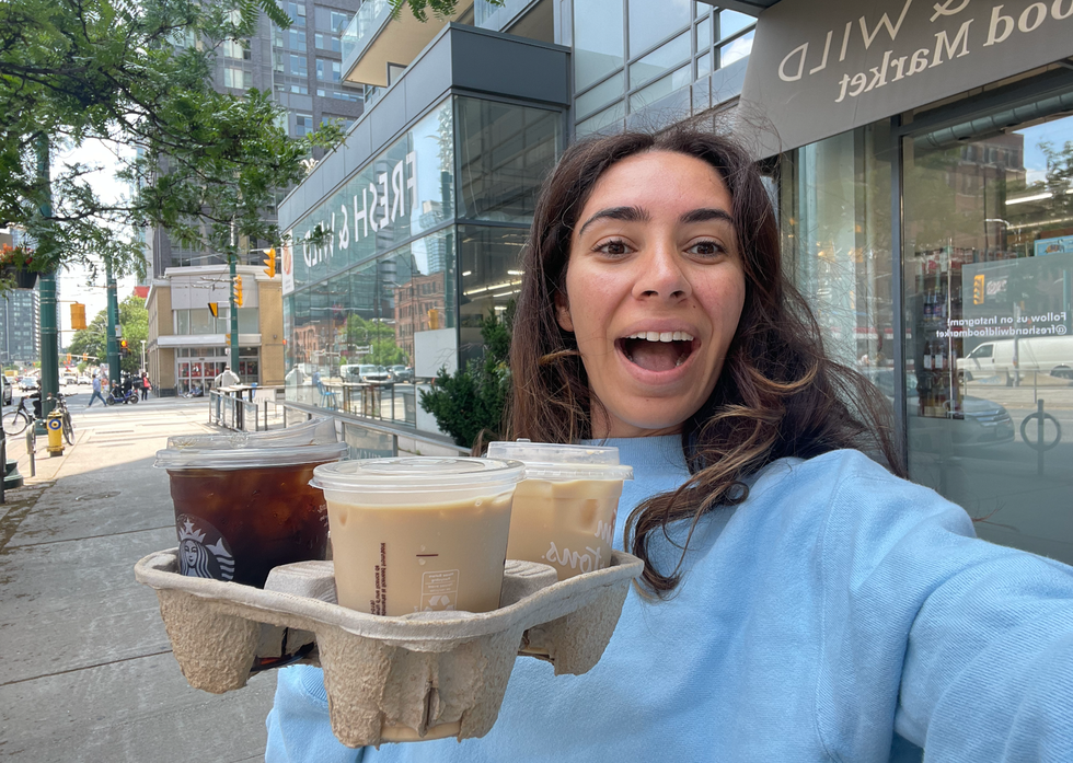 Mira holding her three coffees.