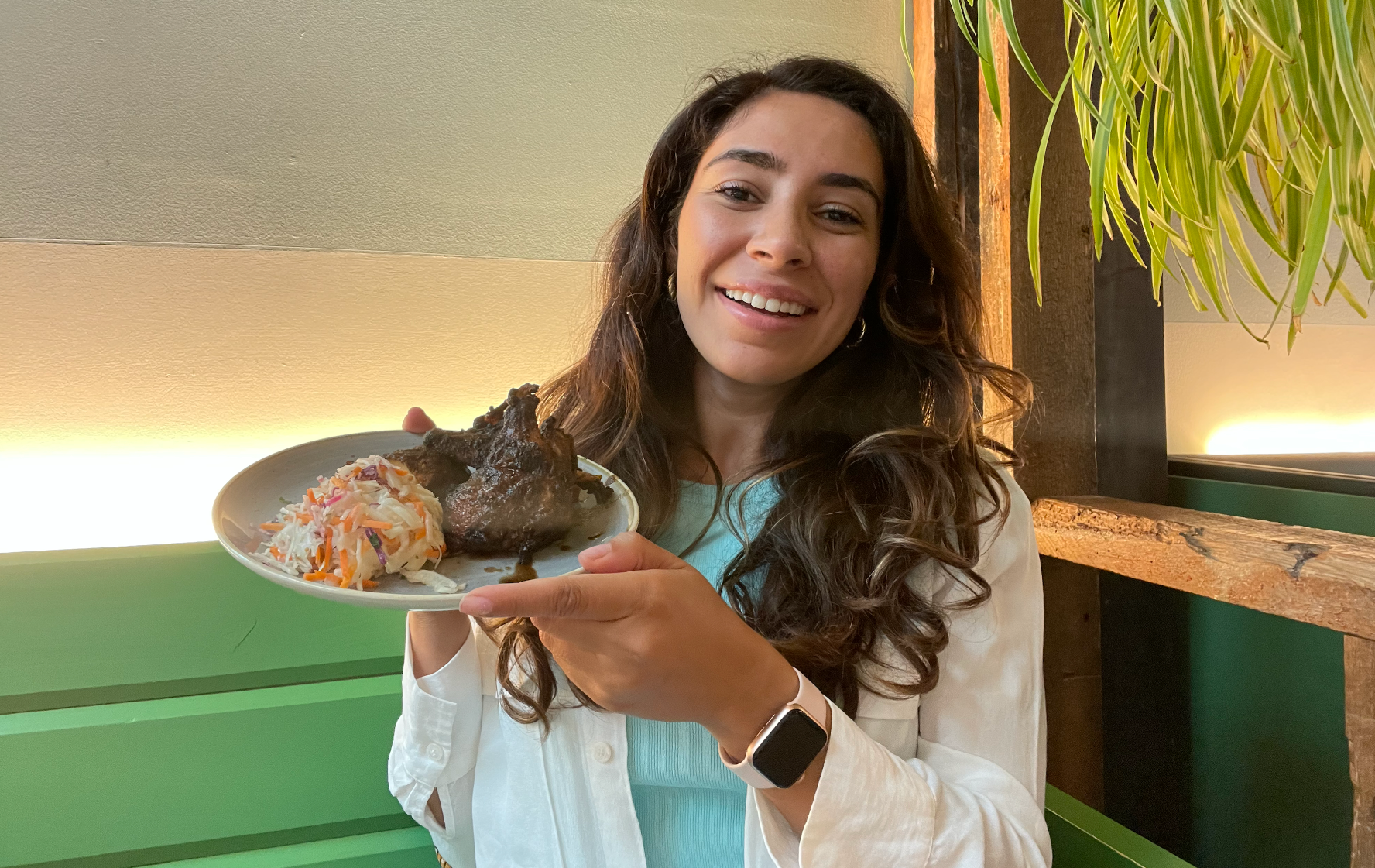 Mira Nabulsi holding her jerk chicken at Chubby's Jamaican Kitchen.
