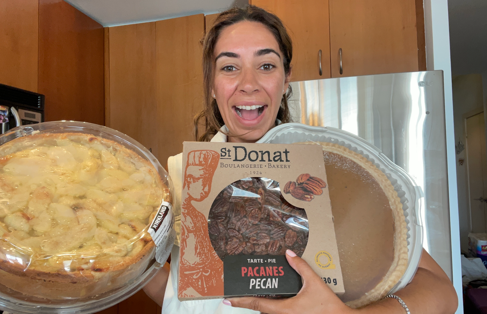 Mira Nabulsi holding three pies from Costco.