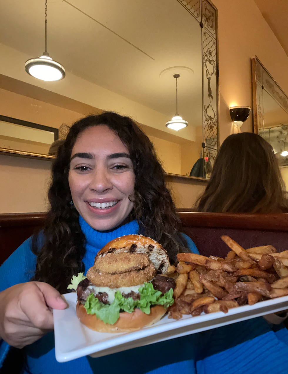 Mira Nabulsi holding up her burger.