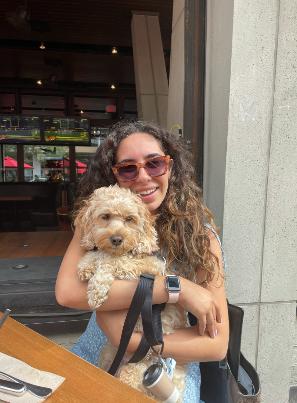Mira with her dog at a Toronto restaurant.