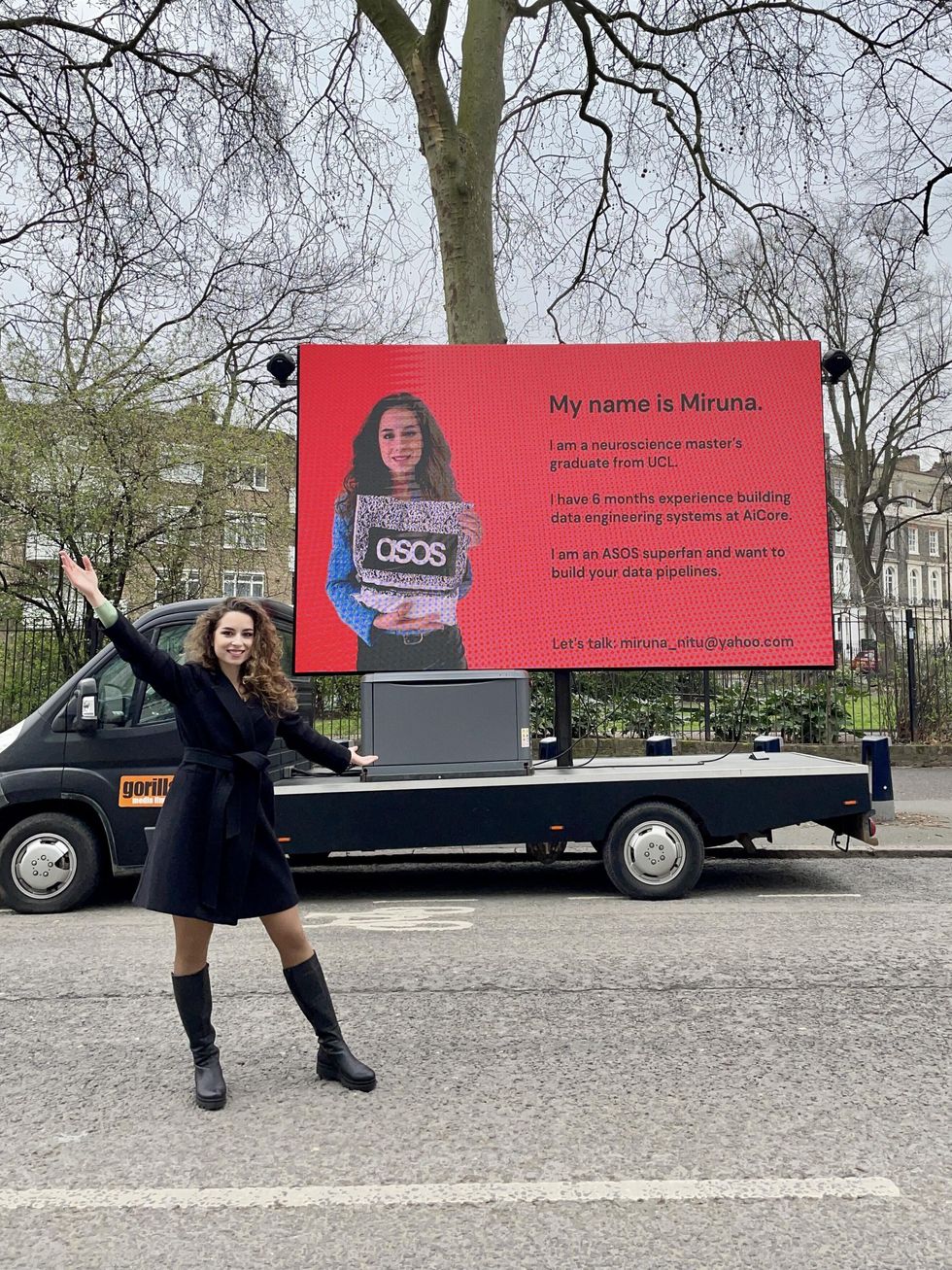 Miruna Nitu in front of a billboard with her resume.