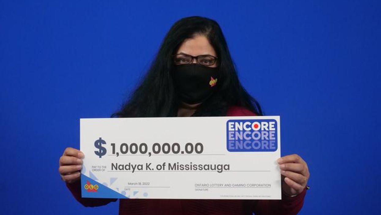 Mississauga resident Nadya Khalil holding her check for $1 million.
