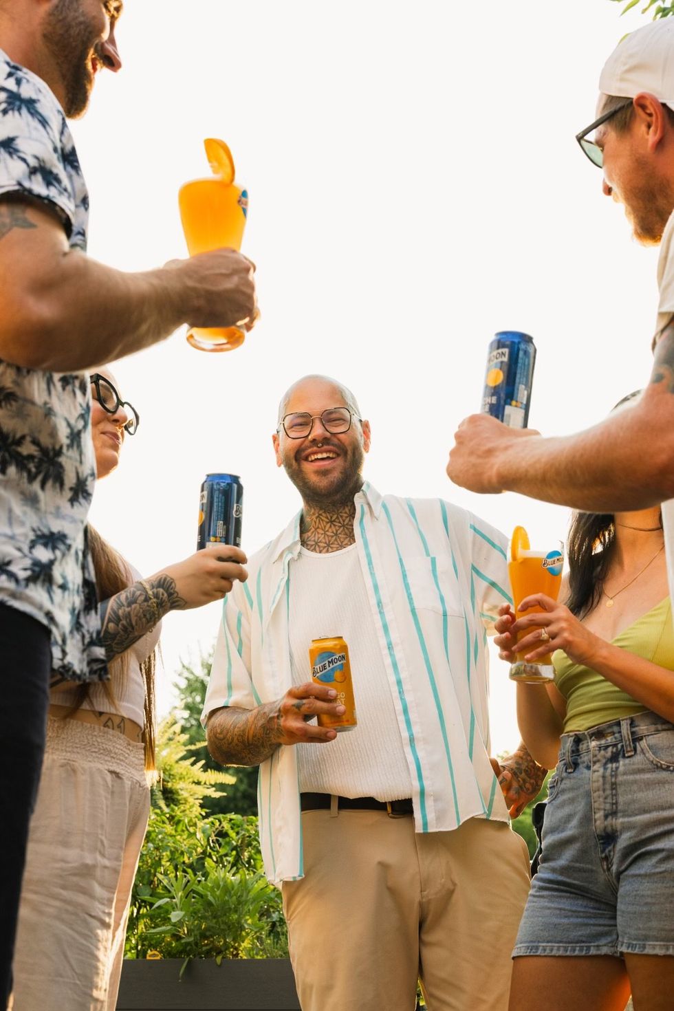 Mitchell Bright chatting with friends while drinking Blue Moon Mango Wheat.
