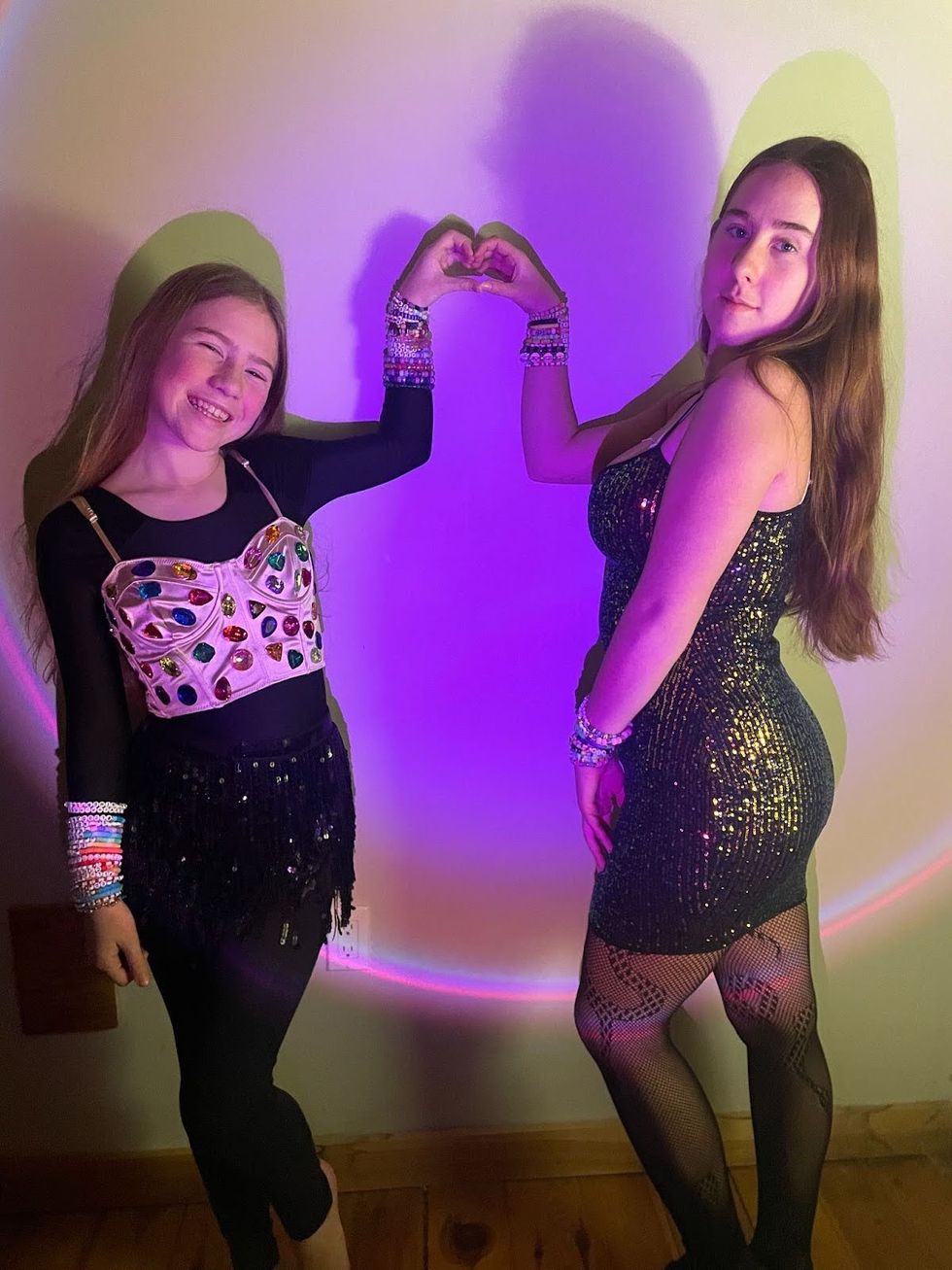 Monica Milton's daughters pose in their Taylor Swift | The Eras Tour outfits.