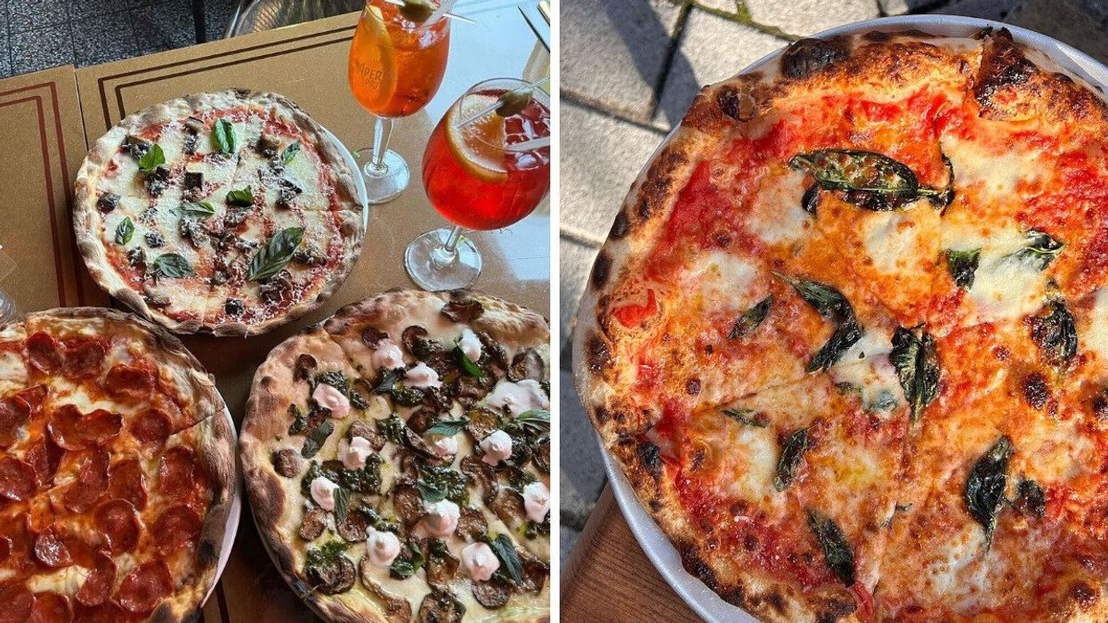 Multiple wood-fired pizzas with various toppings.