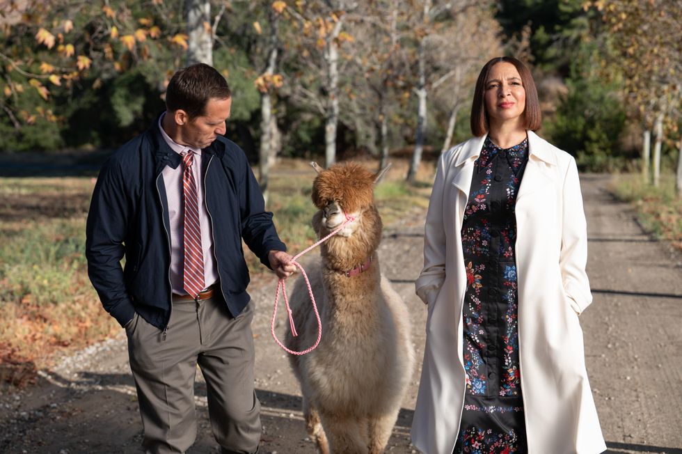 Nat Faxon and Maya Rudolph with a llama in "Loot".