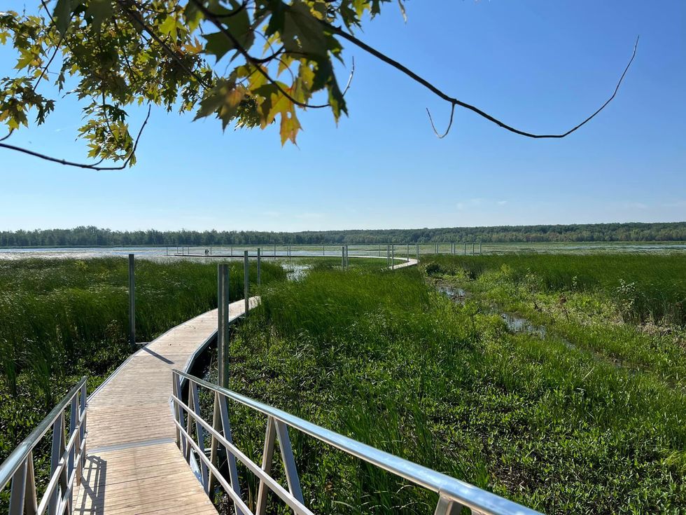 New floating boardwalk trail over a marsh wetland in Quebec.