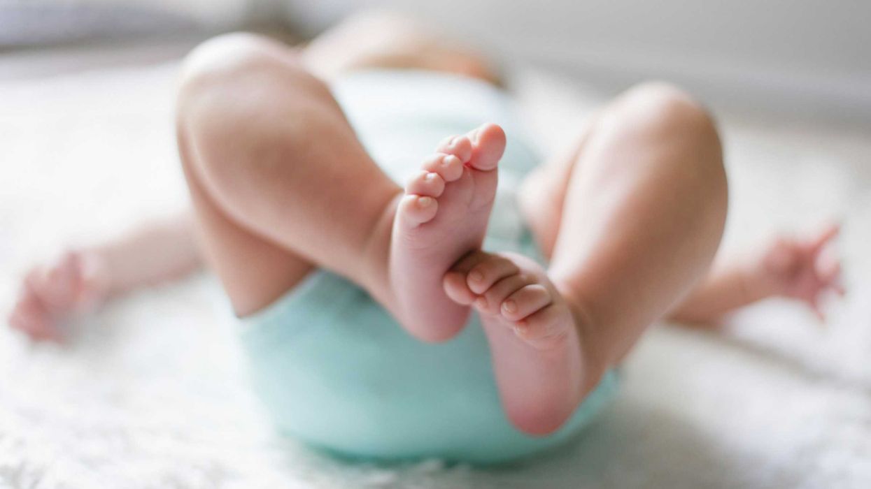 newborn baby in a onesie on a blanket