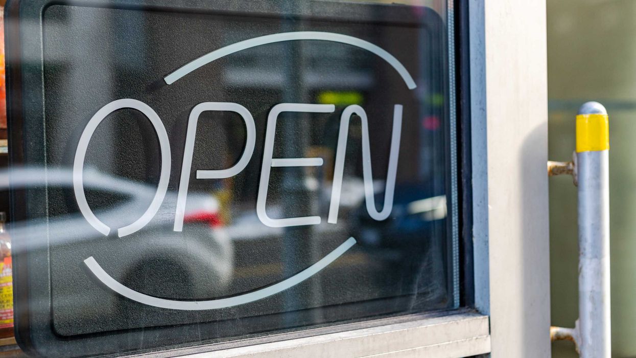 Non-illuminated open sign in a shop window.