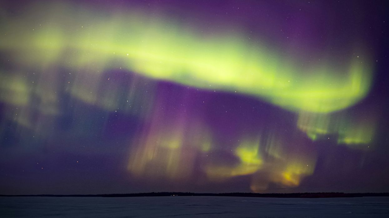 northern lights in the sky above a lake in canada