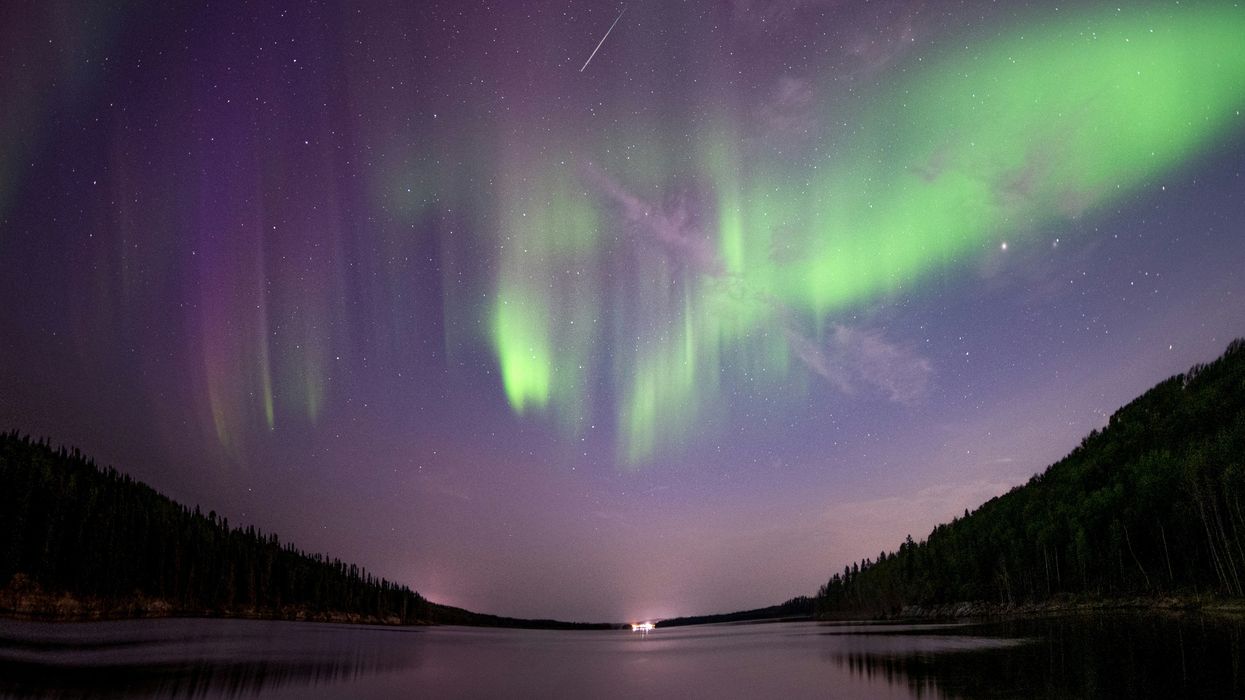 northern lights in the sky above a lake in saskatchewan