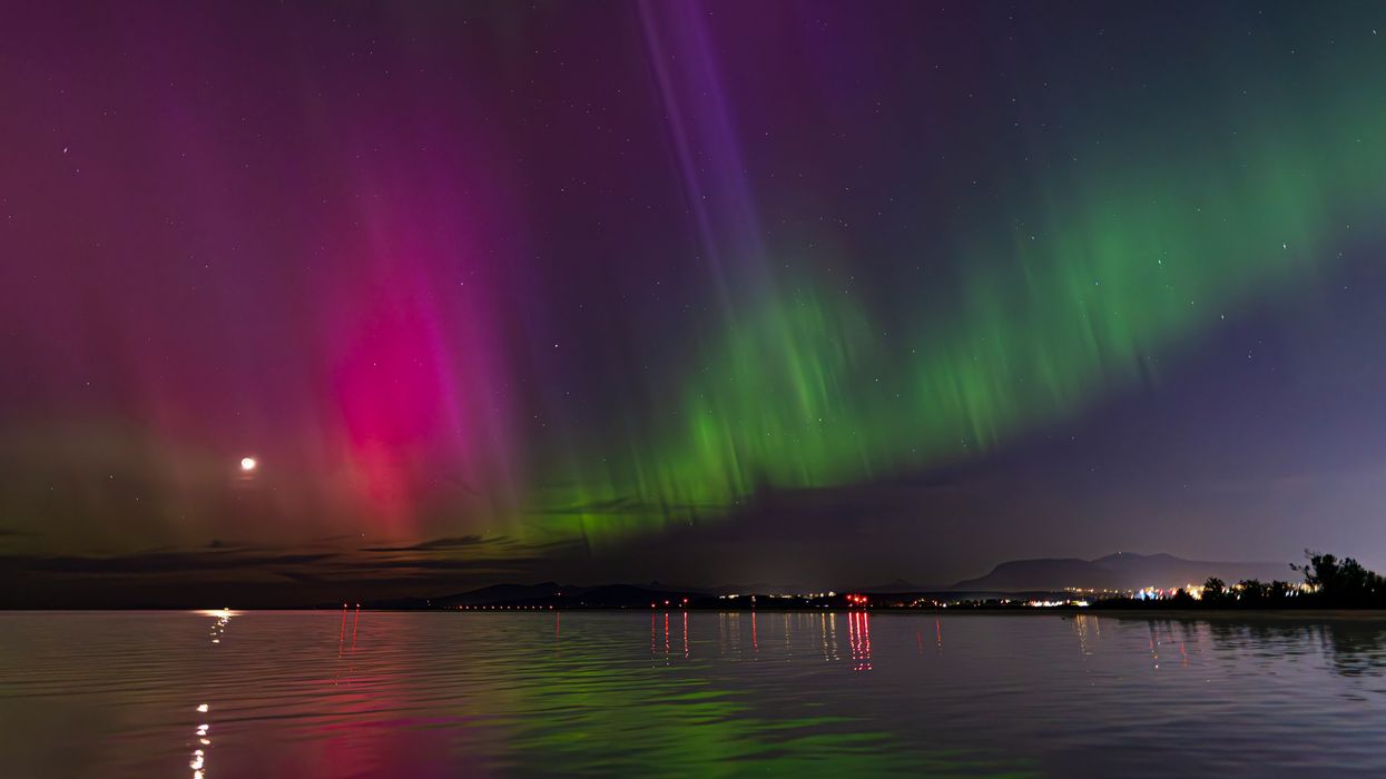 northern lights in the sky over a lake in bc