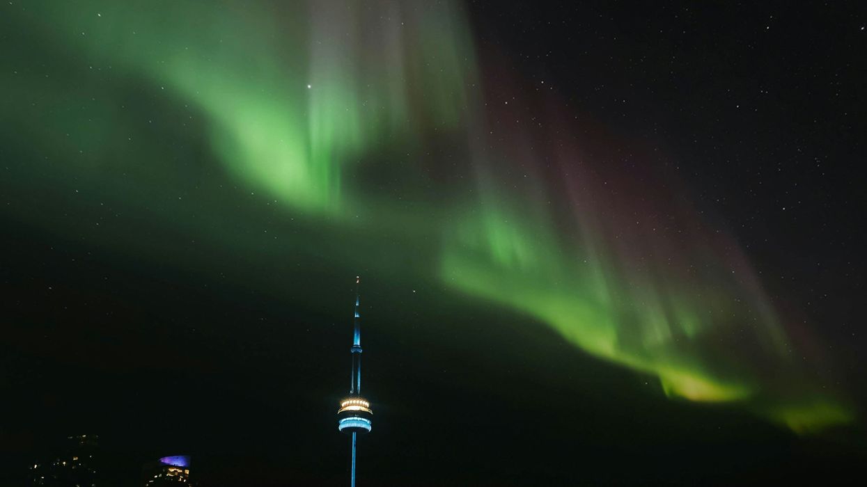 northern lights in the sky over toronto's cn tower