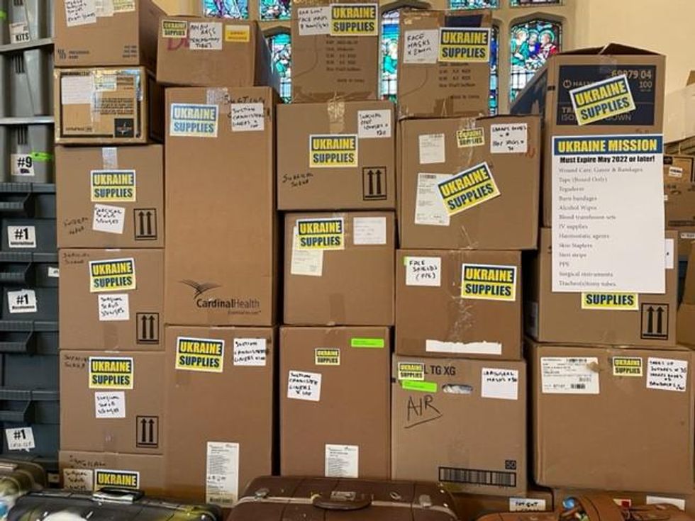 Not Just Tourists storing boxes of donated medical supplies by UHN at a church in Roncesvalles.