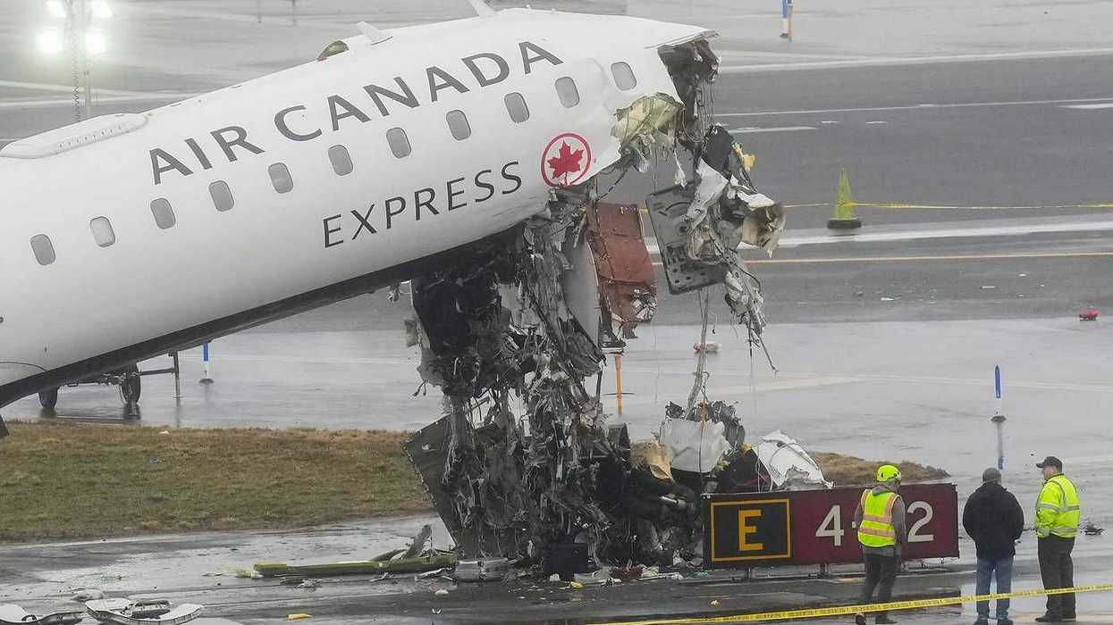 Officials investigate the wreckage of an Air Canada plane crash.