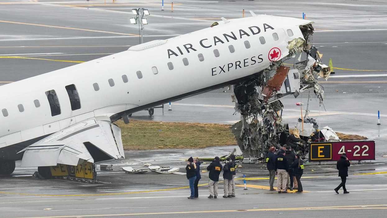 Officials investigate the wreckage of an Air Canada plane crash.